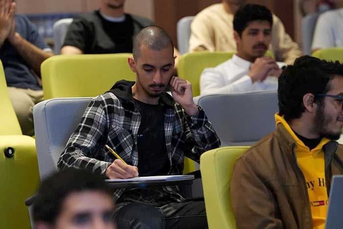 A man learning in the audience of a Biofuel presentation