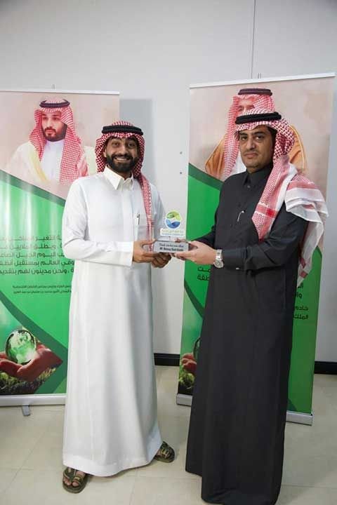 2 team members holding an award